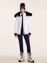 a lady in off white goose down jacket with black jeans